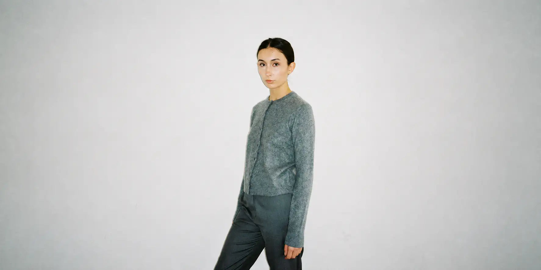 Model wearing the Otis Cardigan in 100% brushed cashmere in grey by Vic and Bert