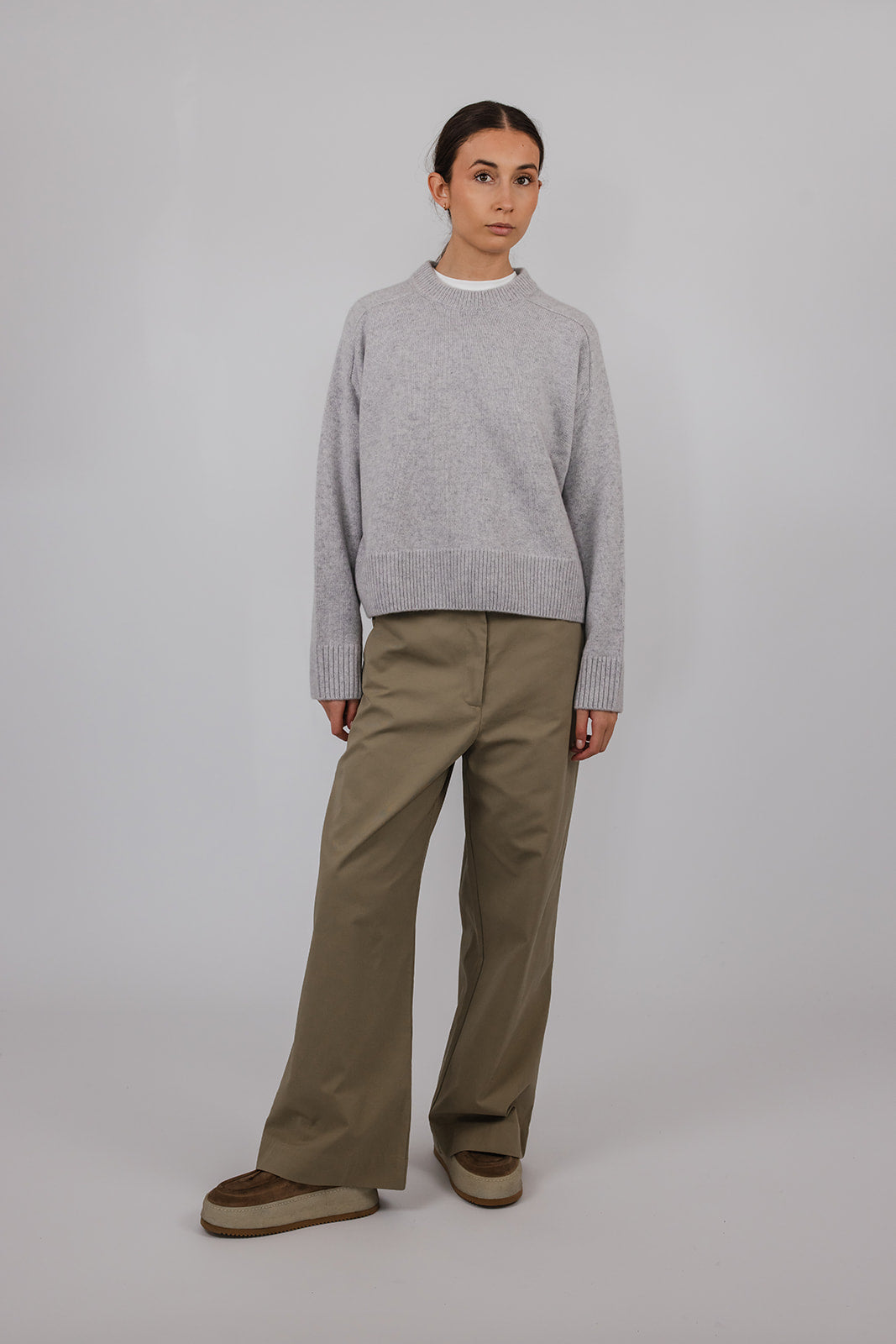 Model wearing a grey cashmere knit with khaki pants by Vic and Bert.