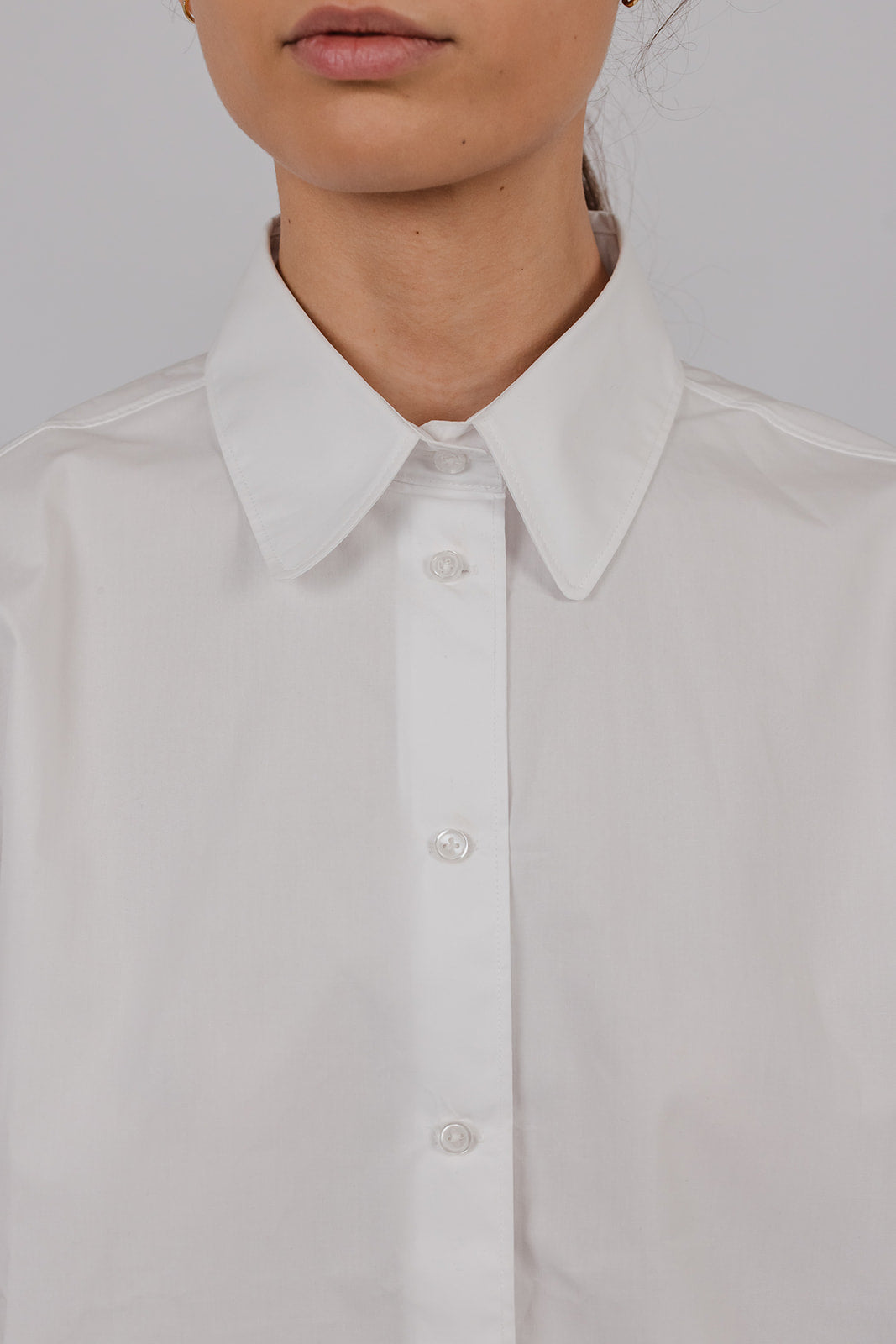 Model wearing a white short sleeve cotton collared shirt by Vic and Bert.