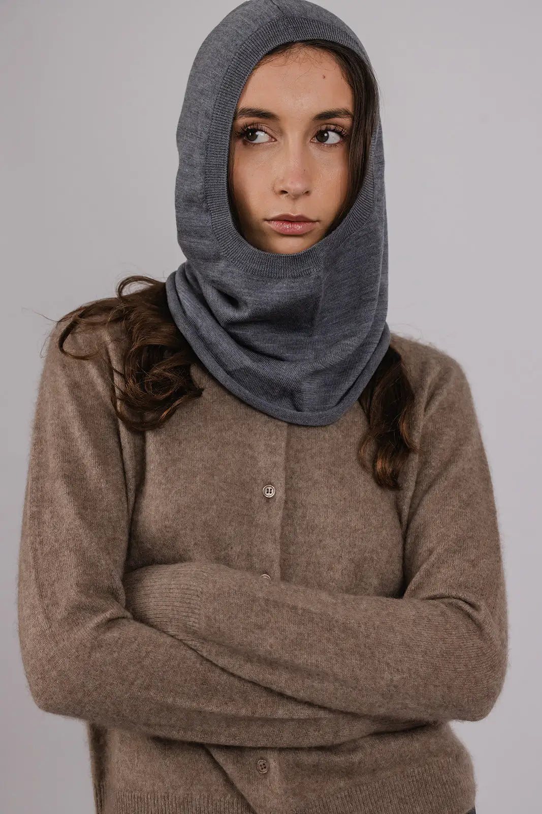 Model wearing a grey merino wool hood by Vic and Bert.