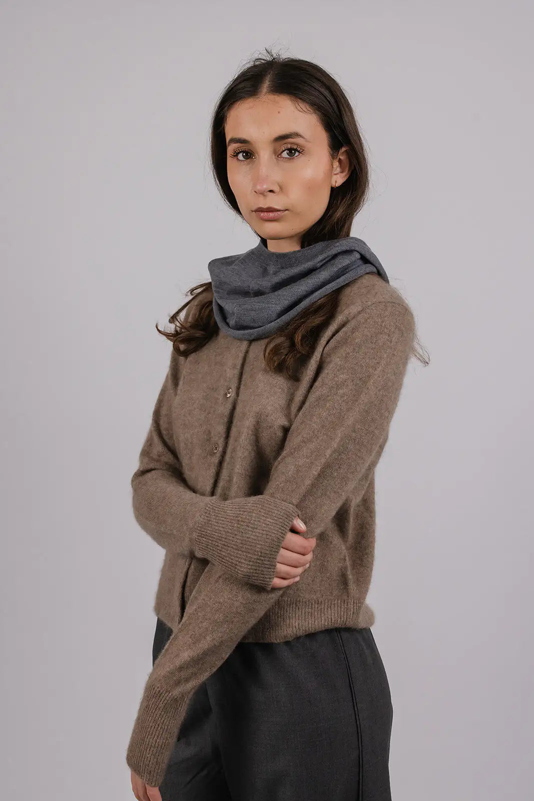 Model wearing a grey merino wool hood by Vic and Bert.