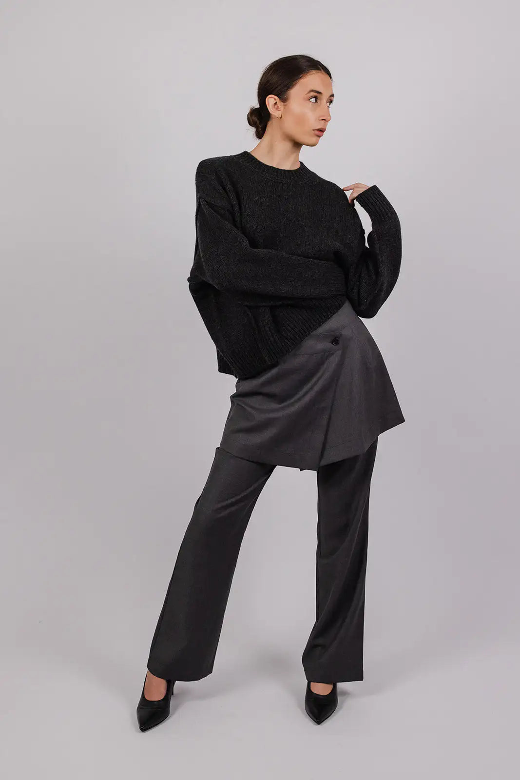 Model wearing an ebony coloured knit and grey suiting mini skirt over matching pants by Vic and Bert.