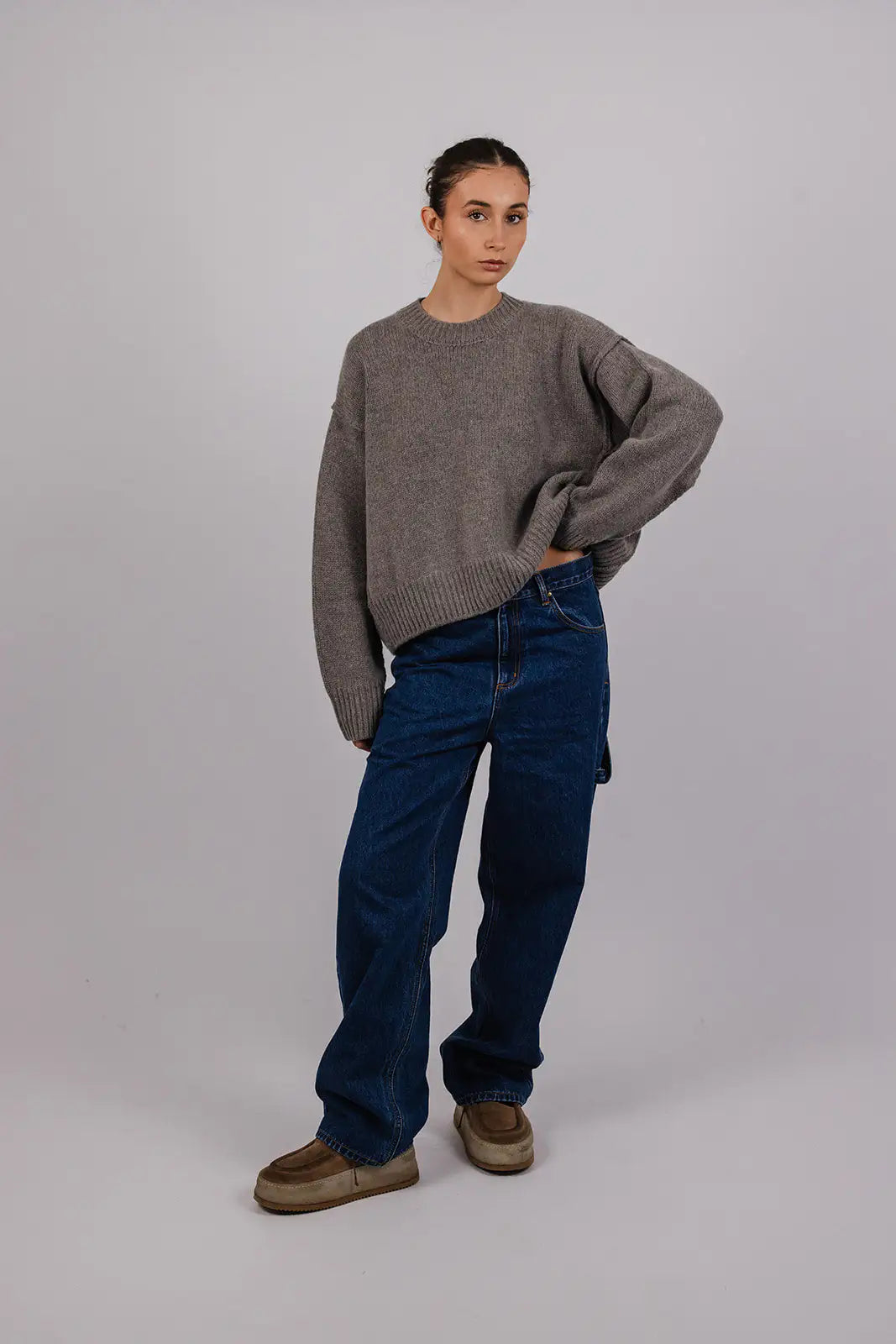 Model wearing blue carpenter jeans by Vic and Bert.