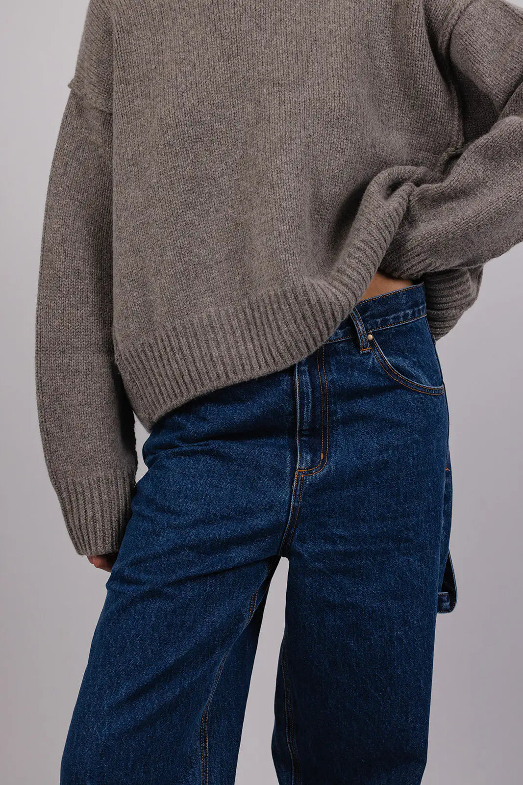 Model wearing blue carpenter jeans by Vic and Bert.