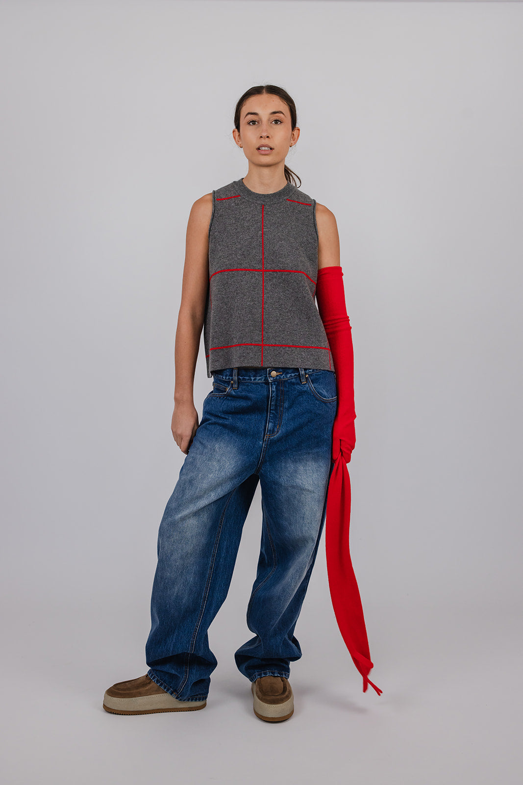 Model wearing long red cashmere gloves by Vic and Bert.