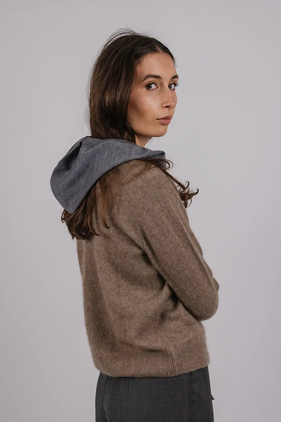 Model wearing a grey merino wool hood by Vic and Bert.