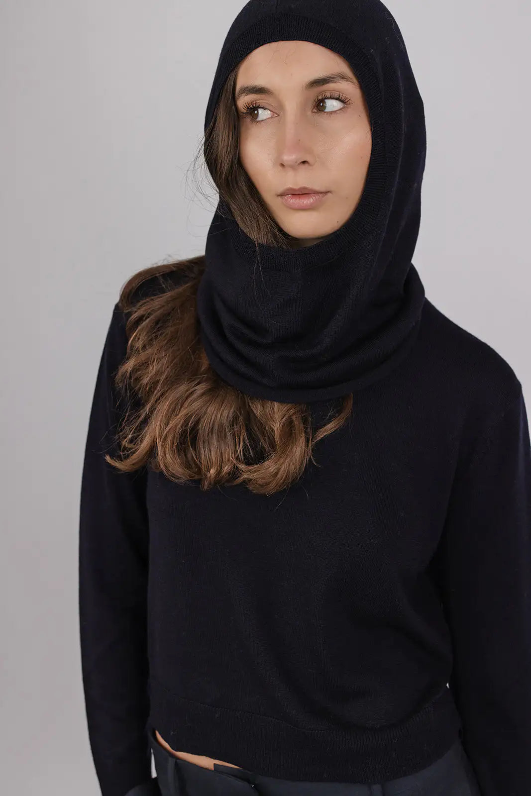 Model wearing a navy merino wool hood by Vic and Bert.