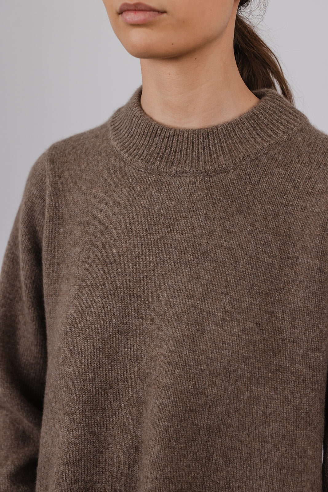 Model wearing a taupe cashmere a-line knit by Vic and Bert.